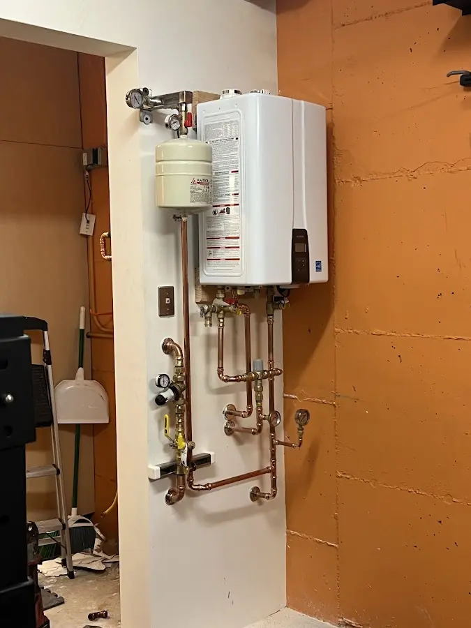 Plumbing technician inspecting water heater connections in Elk Grove